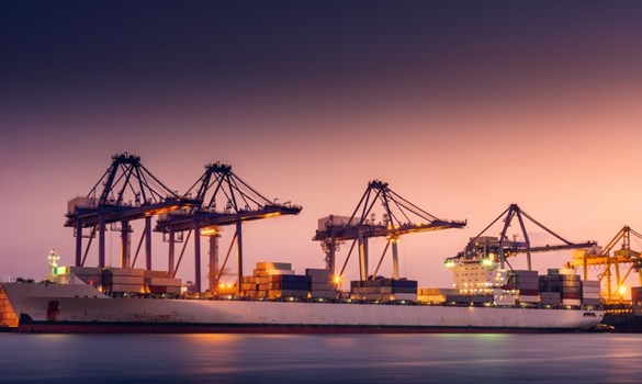 Cargo ship at dock as the sun sets